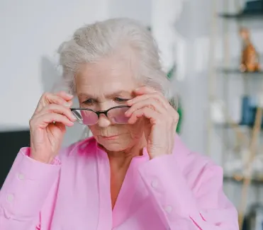 A old woman wearing her glasses